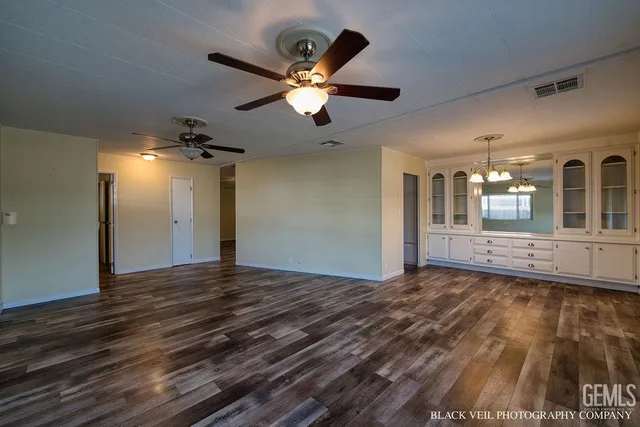a view of a livingroom with a ceiling fan and window