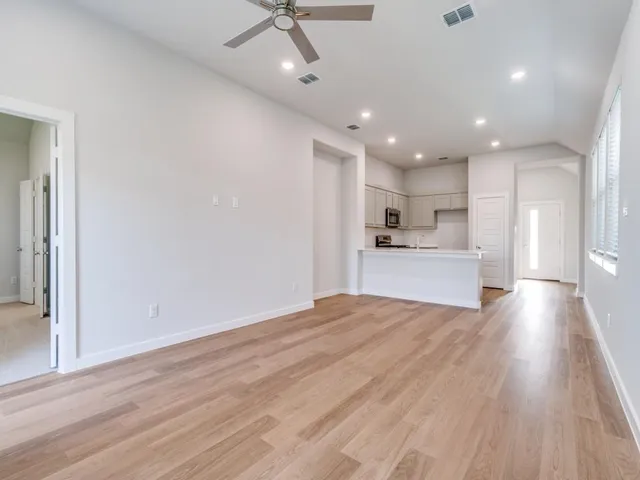 a view of large kitchen with wooden floor and window