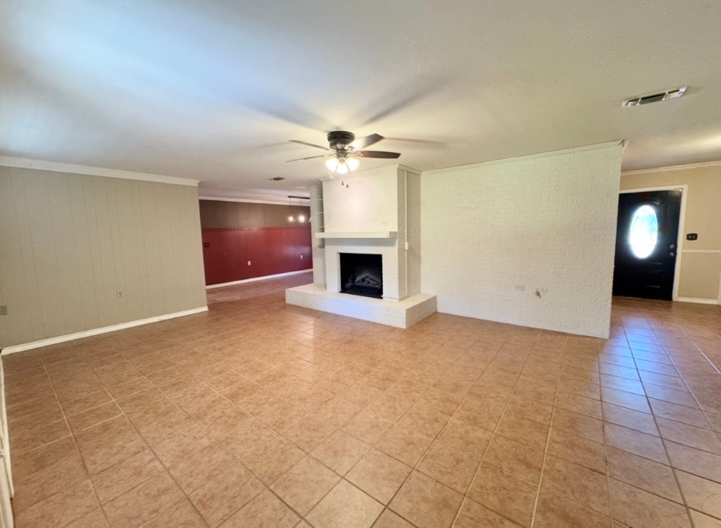 1225 Lake Terrace Drive Elgin, TX 78621 - Photo 5 of 28 an empty room with windows and fireplace