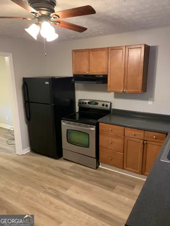 a kitchen with stainless steel appliances granite countertop a refrigerator a stove and a microwave