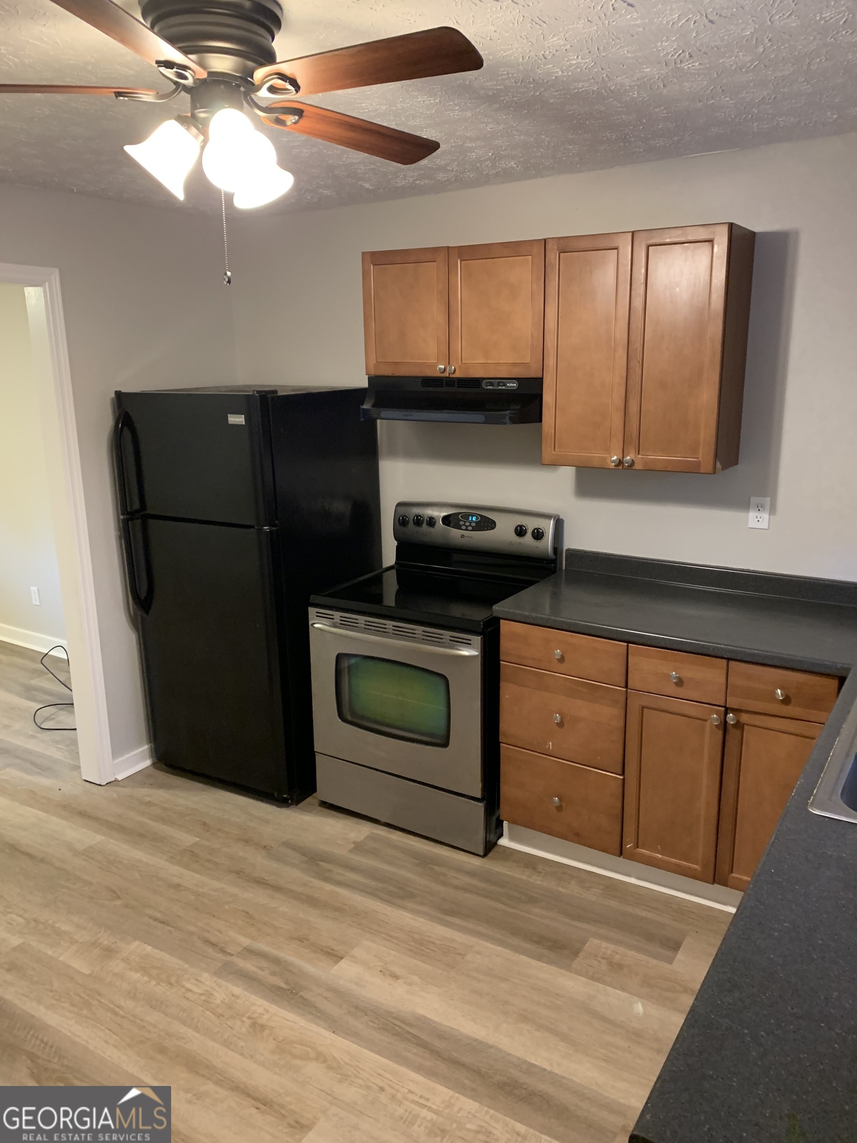 7181 Puckett Street Southwest Covington, GA 30014 - Photo 12 of 18 a kitchen with stainless steel appliances granite countertop a refrigerator a stove and a microwave