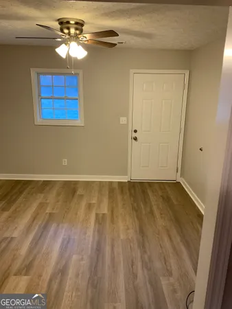 a view of livingroom with hardwood floor and ceiling fan