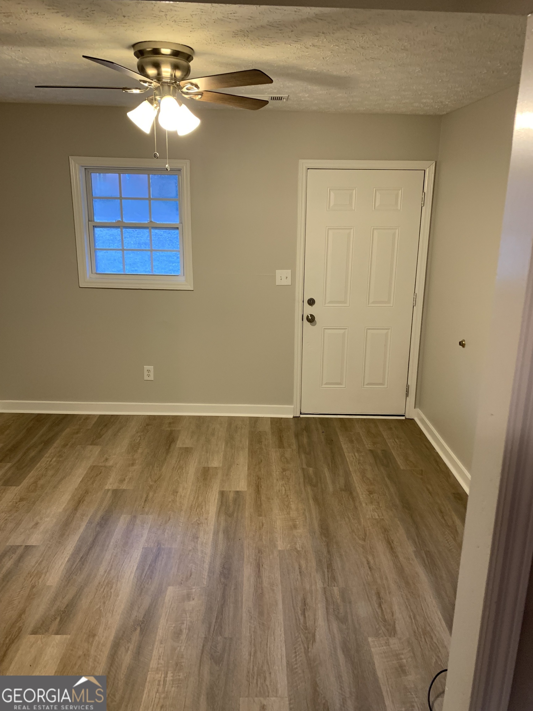7181 Puckett Street Southwest Covington, GA 30014 - Photo 14 of 18 a view of livingroom with hardwood floor and ceiling fan