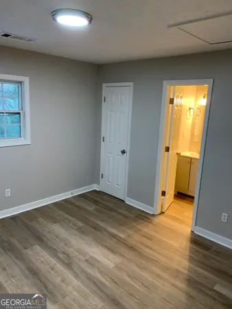 an empty room with wooden floor and closet