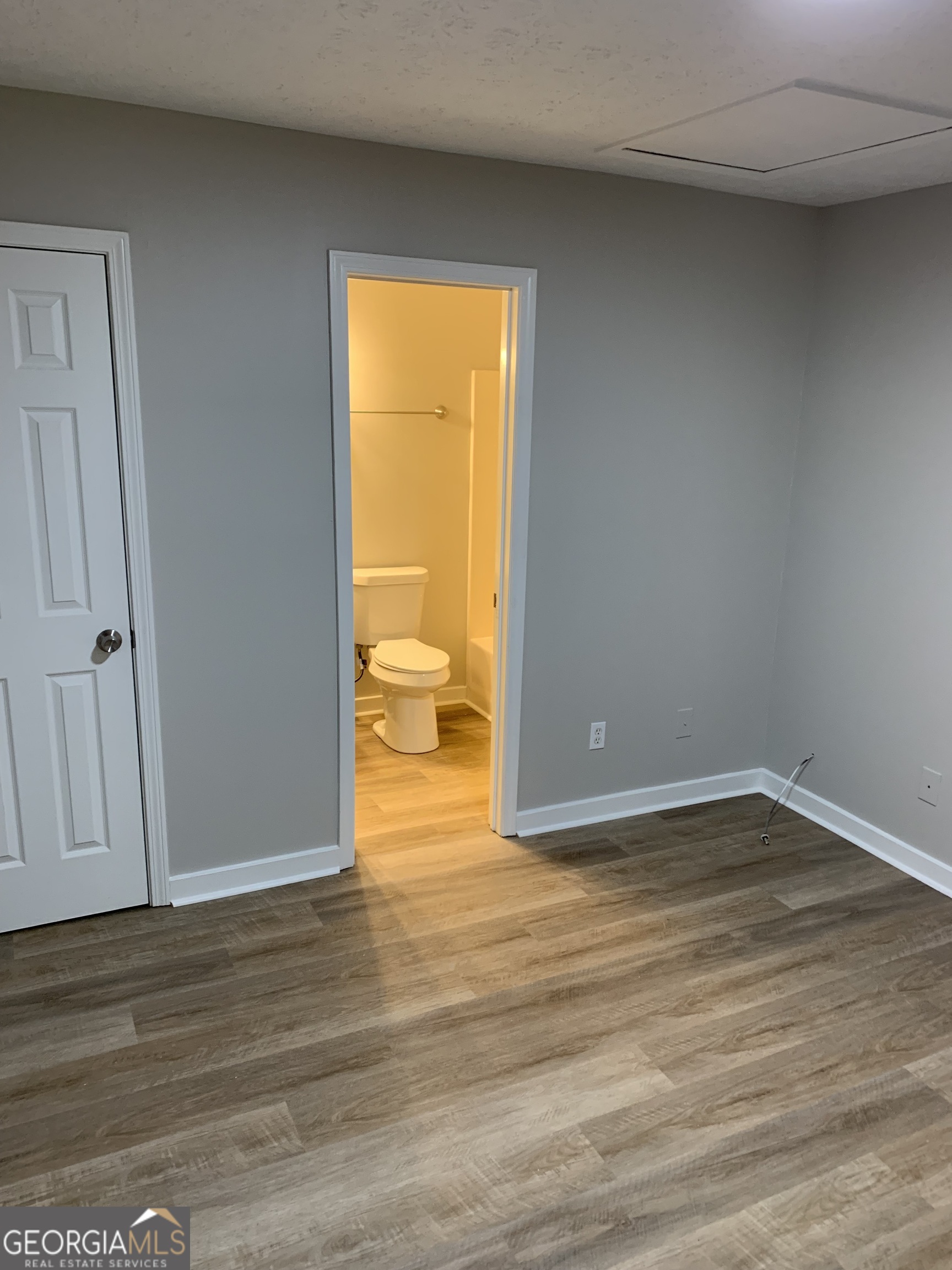 7181 Puckett Street Southwest Covington, GA 30014 - Photo 3 of 18 a view of an empty room and wooden floor and a window