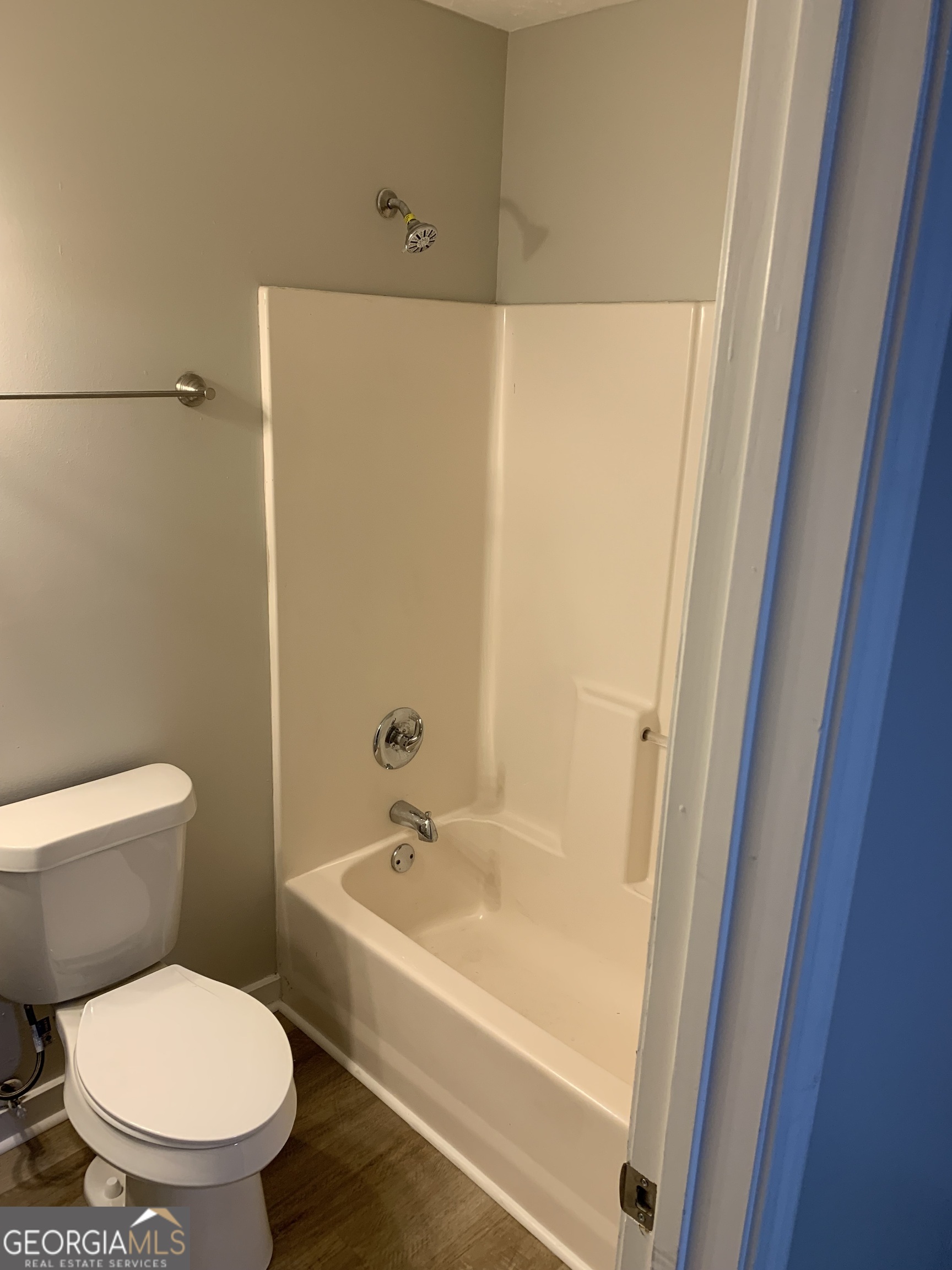 7181 Puckett Street Southwest Covington, GA 30014 - Photo 5 of 18 a white toilet sitting next to a bathroom sink