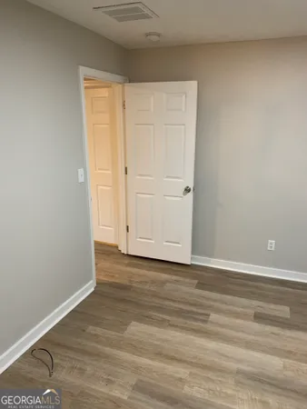 a view of an empty room and wooden floor