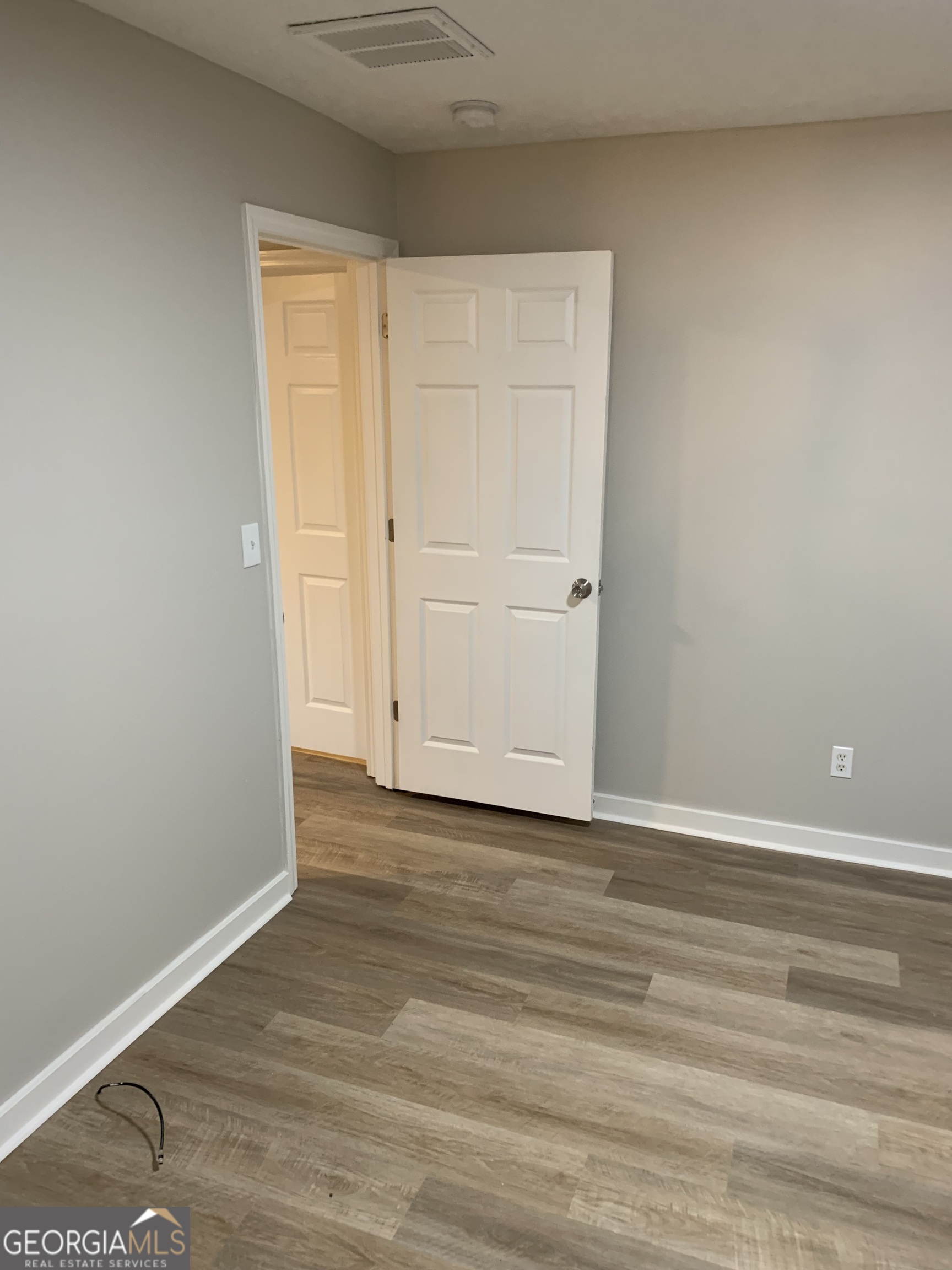 7181 Puckett Street Southwest Covington, GA 30014 - Photo 7 of 18 a view of an empty room and wooden floor