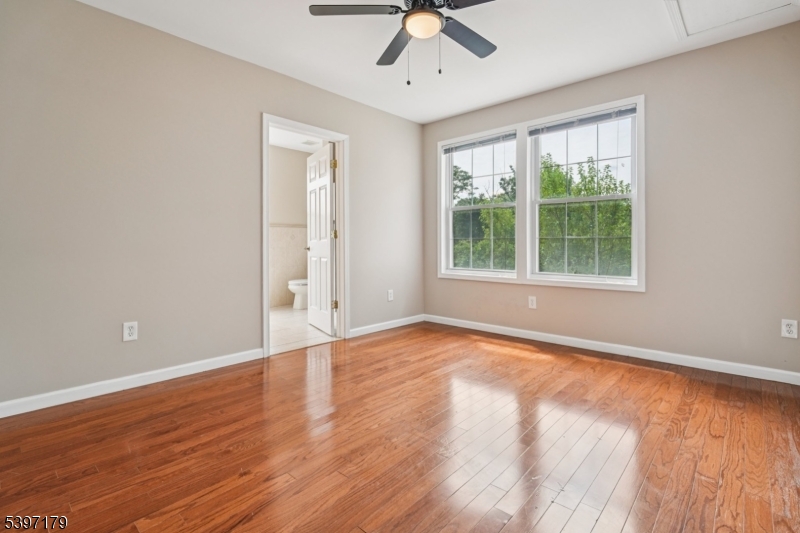 141 Walnut Street, Unit 2 Montclair, NJ 07042 - Photo 11 of 23 a view of an empty room with a window and wooden floor