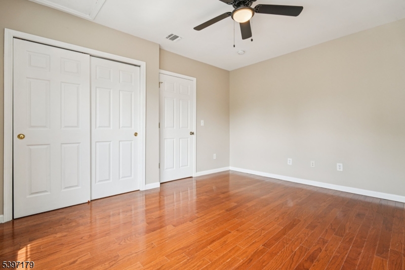 141 Walnut Street, Unit 2 Montclair, NJ 07042 - Photo 14 of 23 a view of an empty room with window and wooden floor