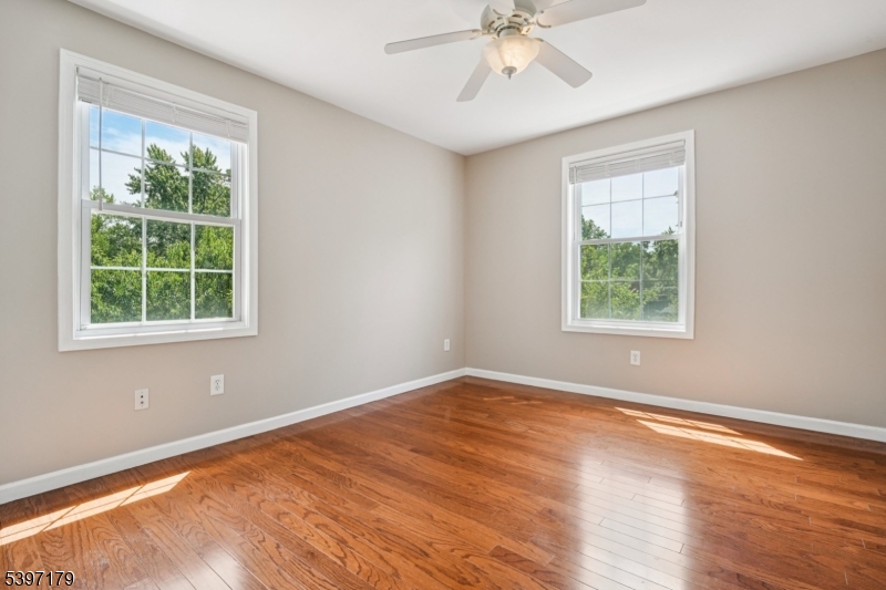 141 Walnut Street, Unit 2 Montclair, NJ 07042 - Photo 18 of 23 an empty room with a window and wooden floor