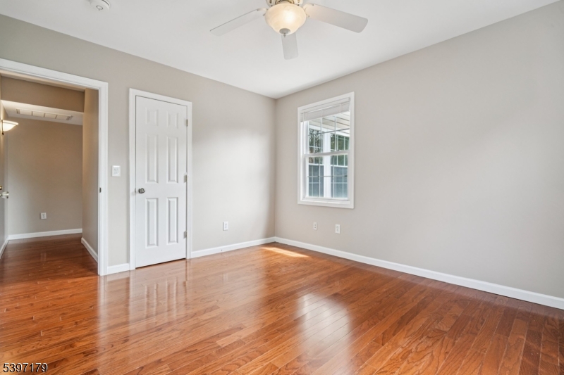 141 Walnut Street, Unit 2 Montclair, NJ 07042 - Photo 21 of 23 an empty room with wooden floor and windows