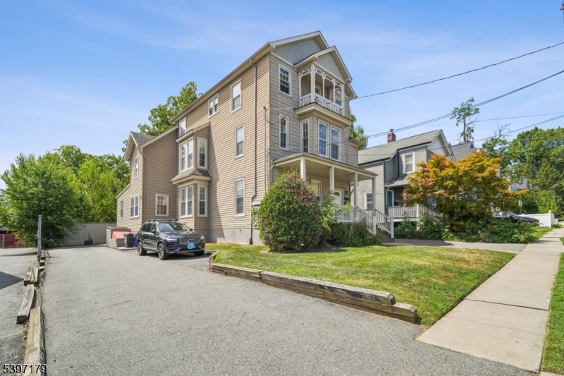 141 Walnut Street, Unit 2 Montclair, NJ 07042 - Photo 23 of 23 a view of a white house with a big yard and large trees