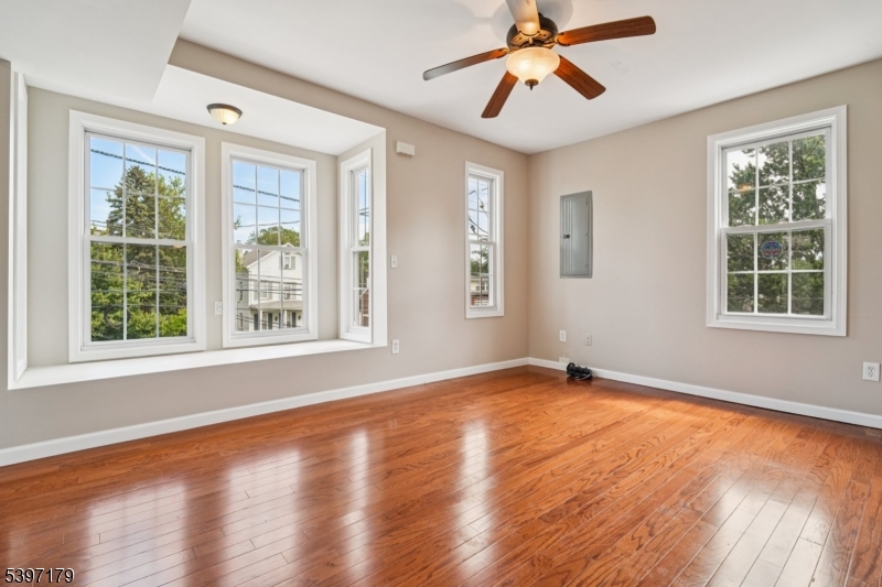 141 Walnut Street, Unit 2 Montclair, NJ 07042 - Photo 3 of 23 a view of an empty room with window and wooden floor