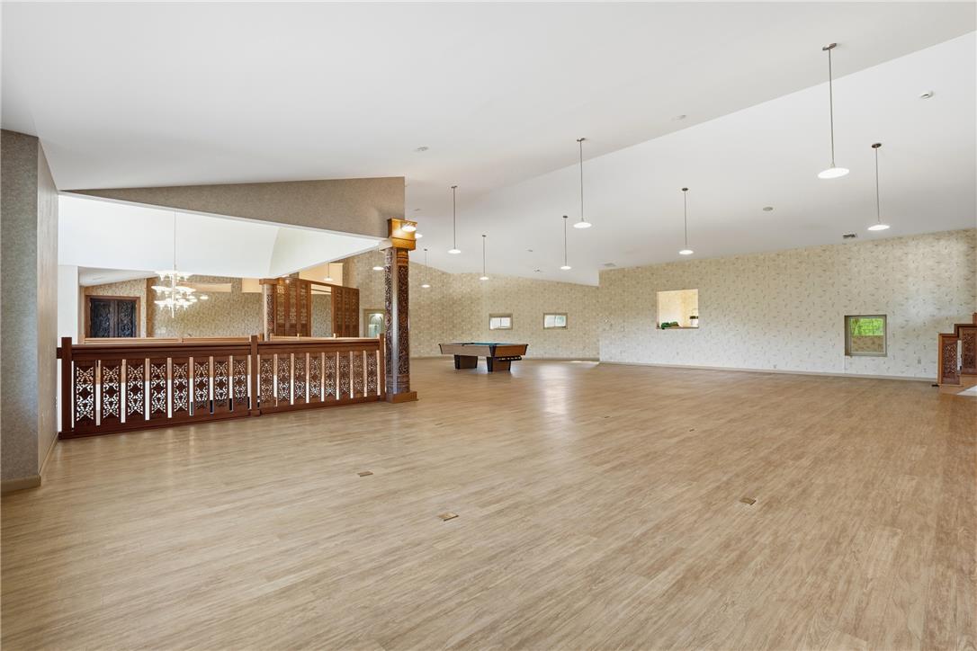6271 Batman Road Zionsville, PA 18092 - Photo 74 of 100 An expansive recreation room with hardwood flooring and a stylish bar area, perfect for entertaining.