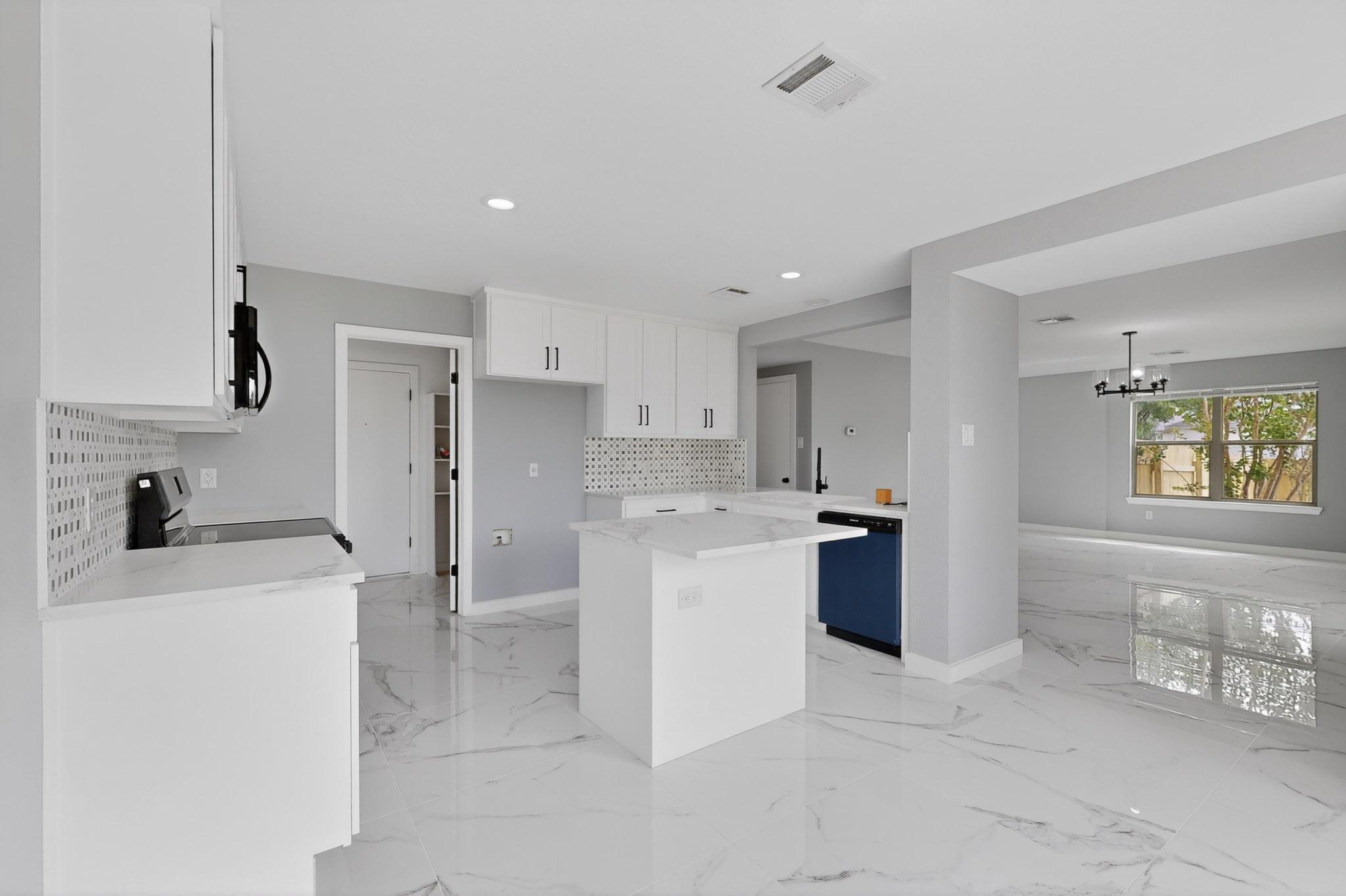1200 Apollo Circle Round Rock, TX 78664 - Photo 13 of 45 a kitchen with a refrigerator and a sink