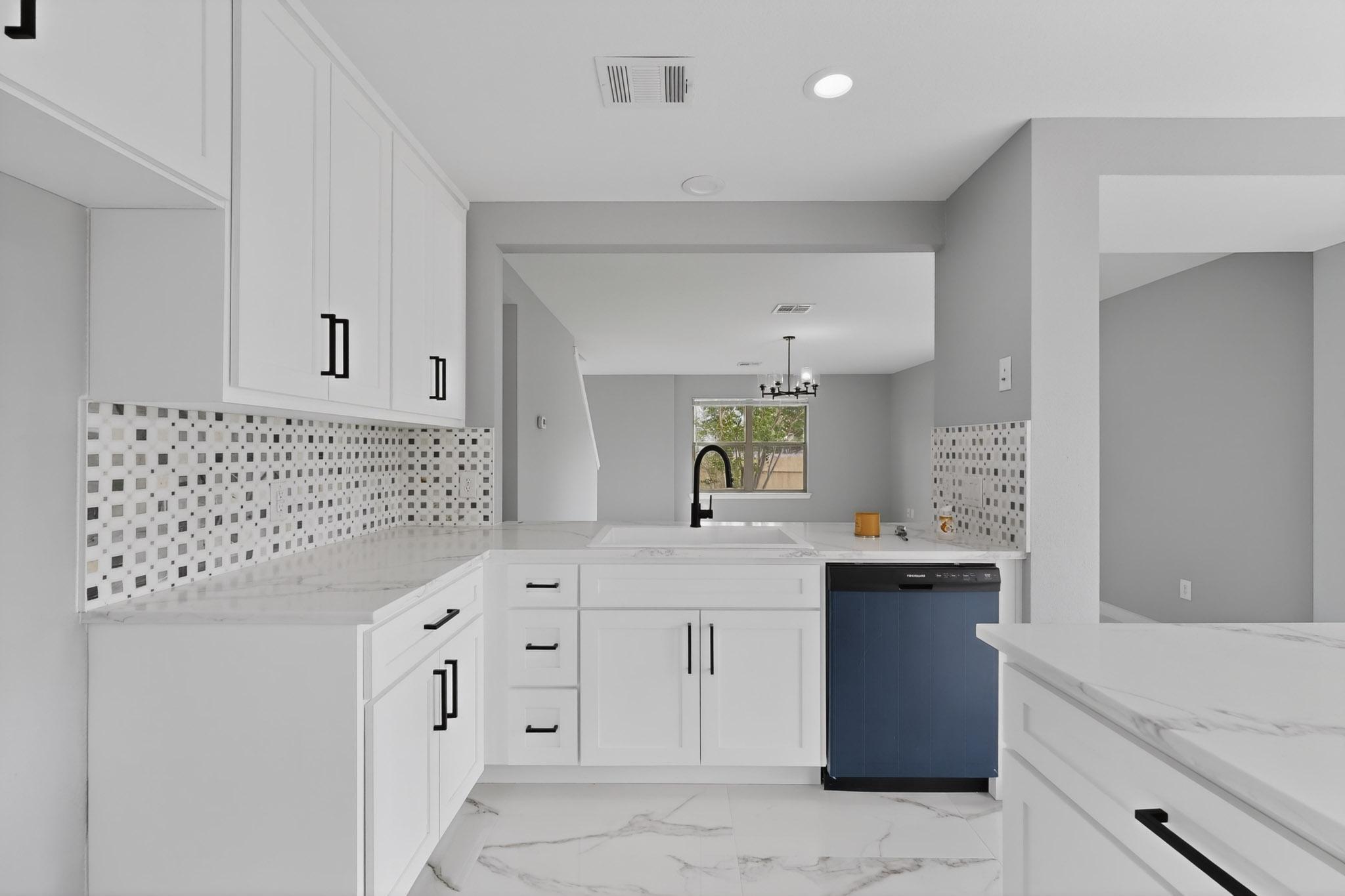 1200 Apollo Circle Round Rock, TX 78664 - Photo 15 of 45 a kitchen with a sink stove and cabinets