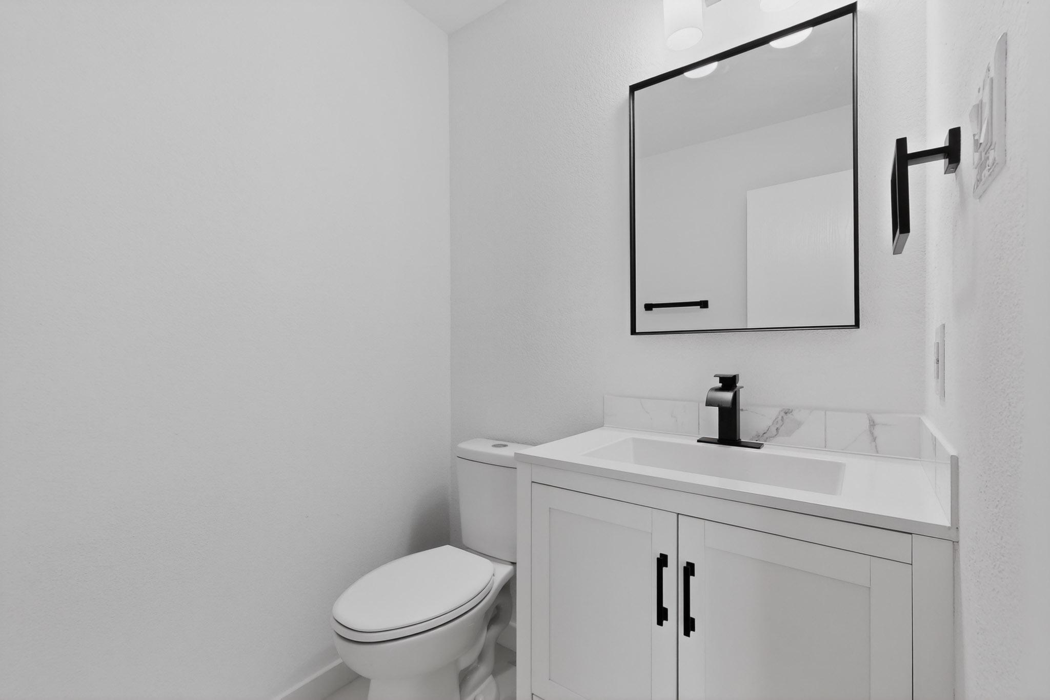 1200 Apollo Circle Round Rock, TX 78664 - Photo 21 of 45 a bathroom with a toilet sink and mirror