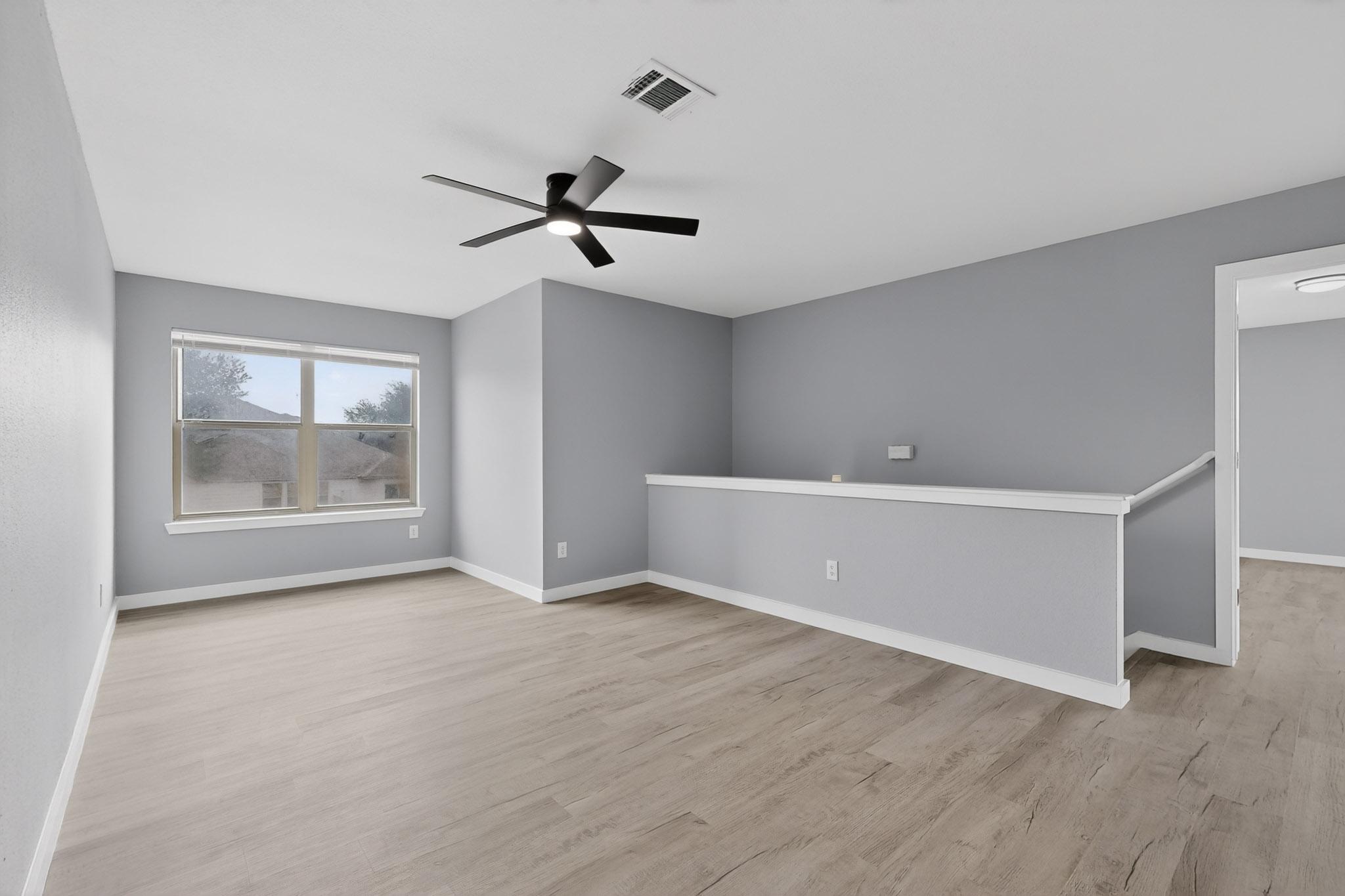 1200 Apollo Circle Round Rock, TX 78664 - Photo 24 of 45 a view of an empty room with a window and wooden floor