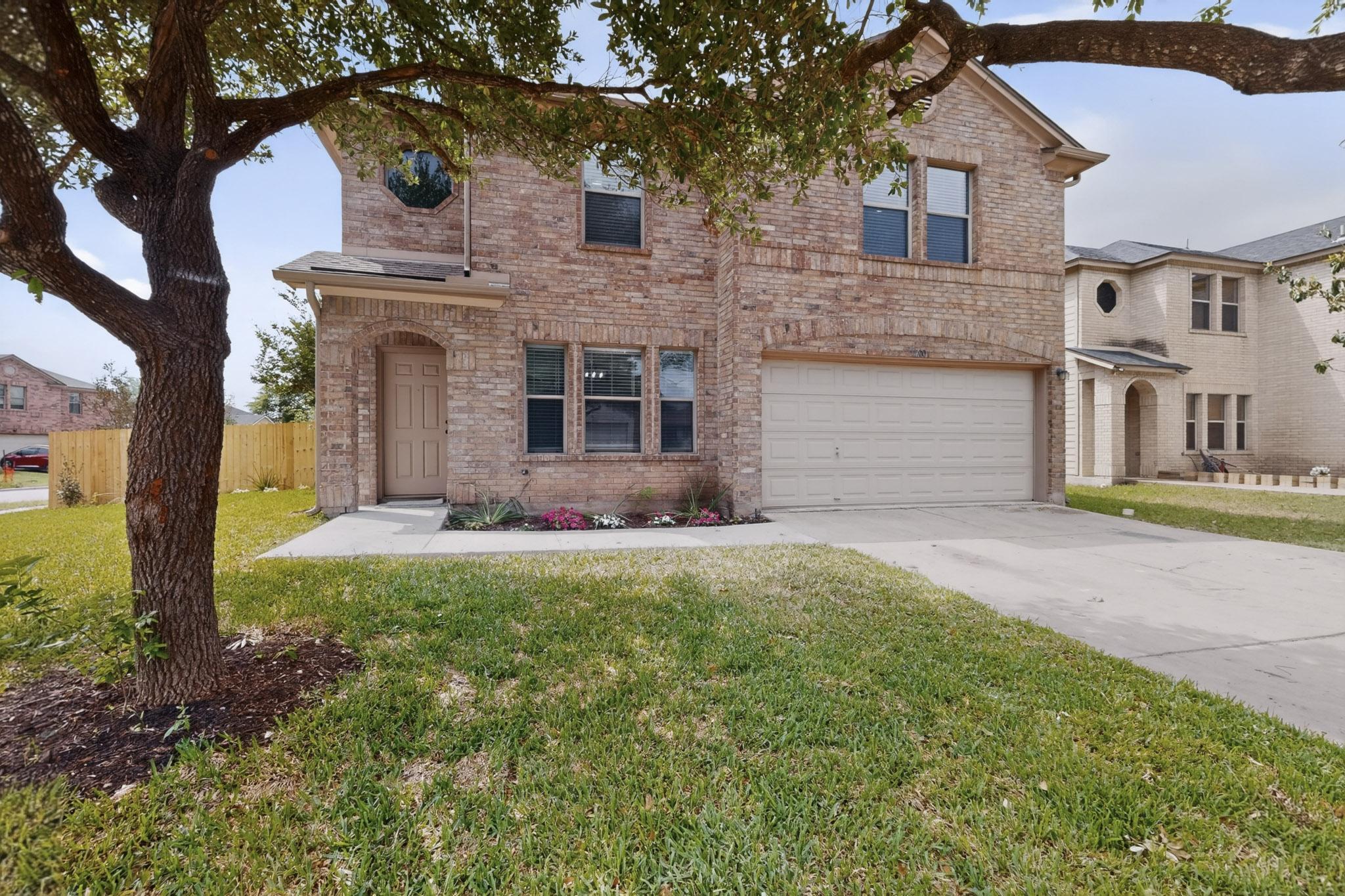 1200 Apollo Circle Round Rock, TX 78664 - Photo 3 of 45 a front view of a house with a garden and yard