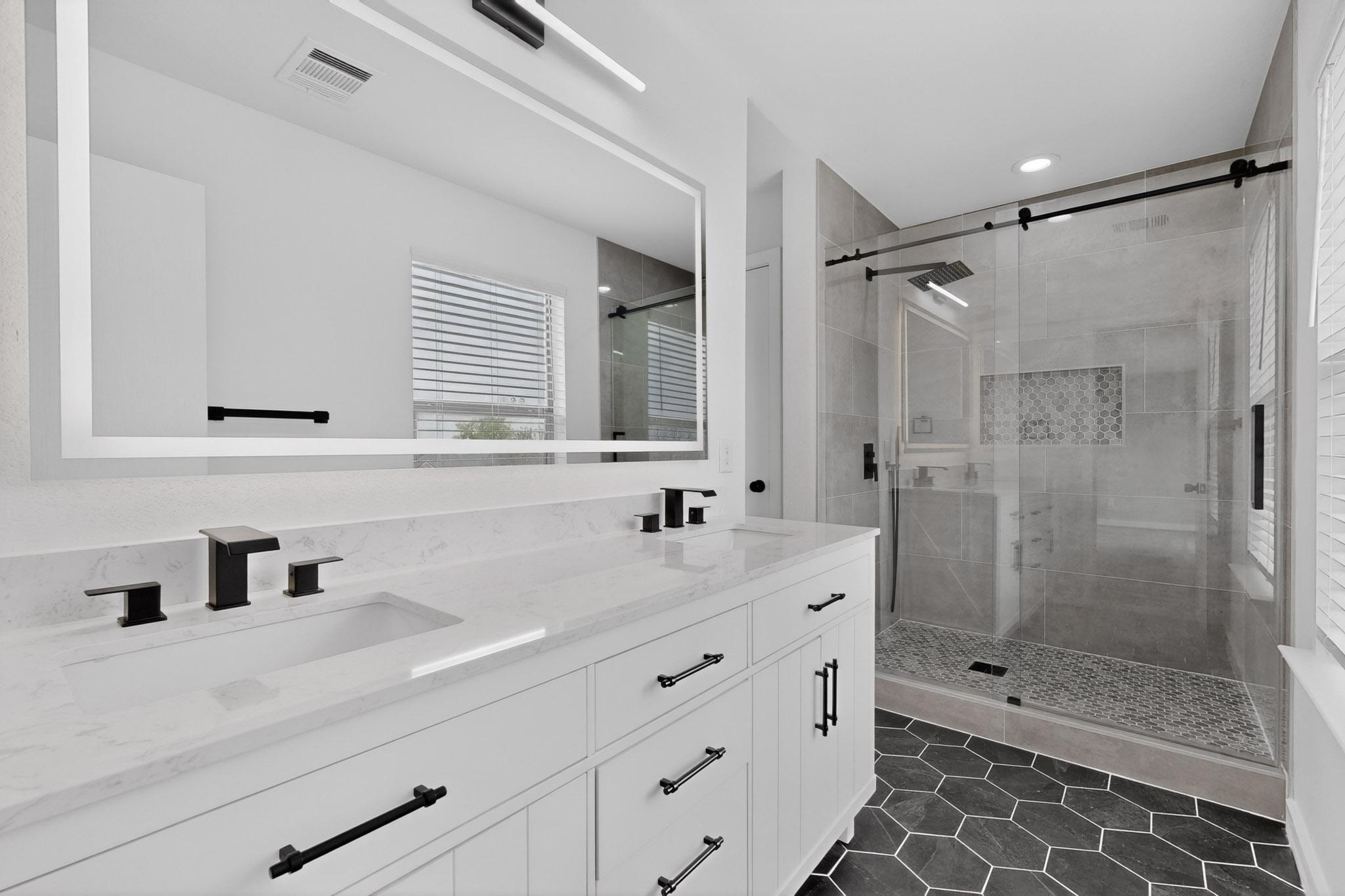 1200 Apollo Circle Round Rock, TX 78664 - Photo 31 of 45 a bathroom with a double vanity sink mirror and shower