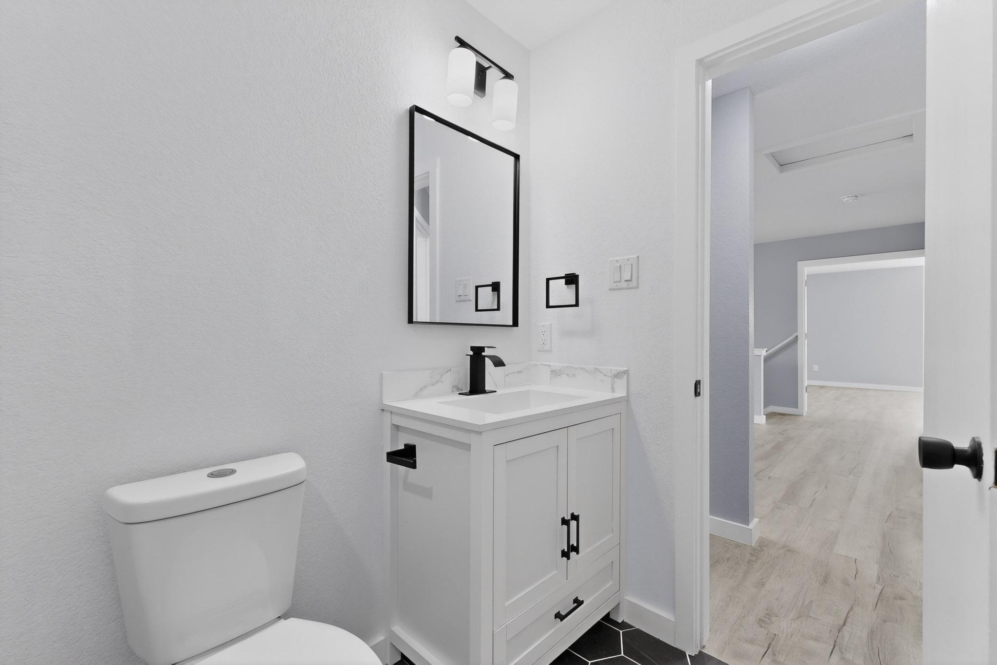 1200 Apollo Circle Round Rock, TX 78664 - Photo 35 of 45 a bathroom with a toilet a sink and mirror