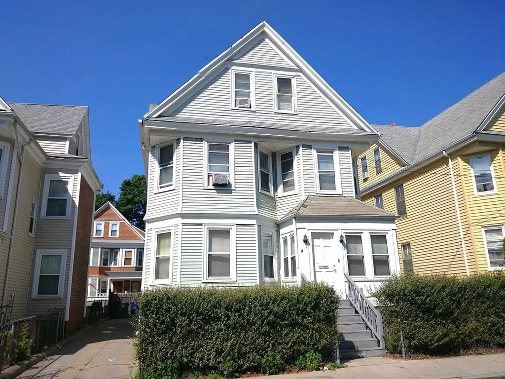 a front view of a house with a yard