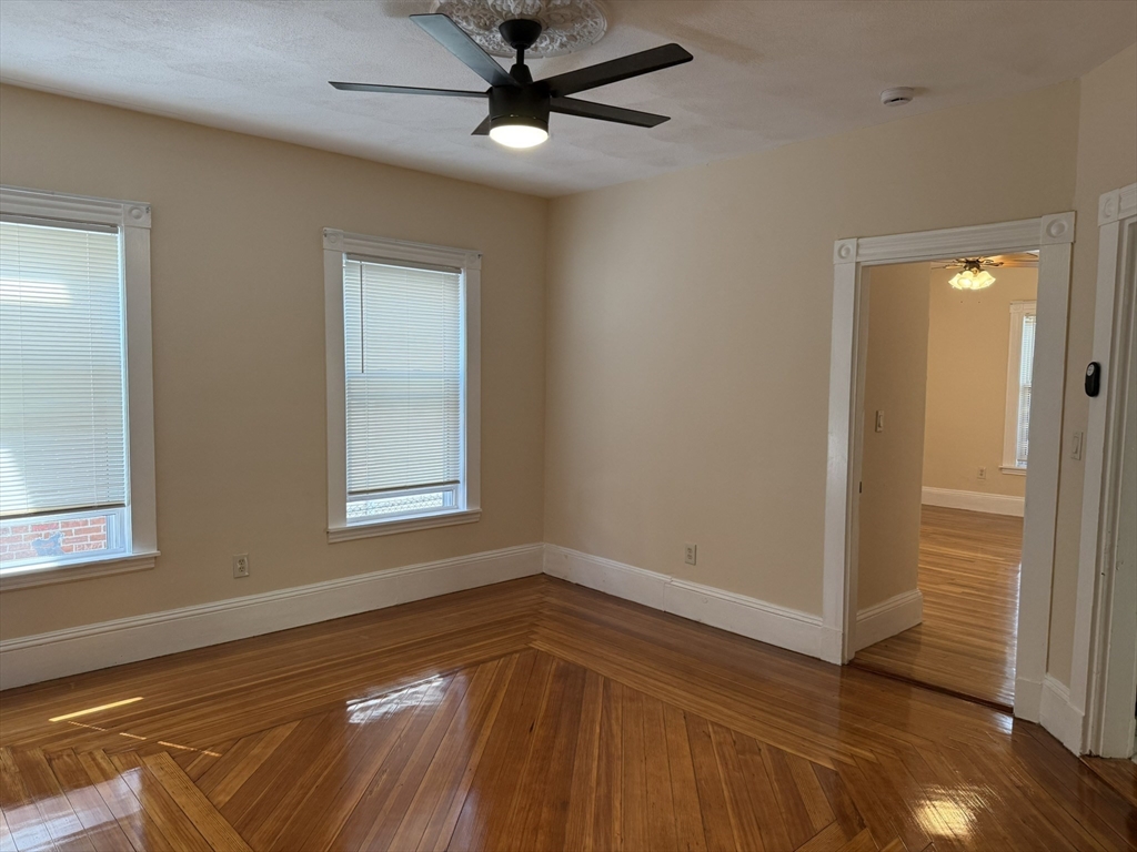 4 Dever Street, Unit 1 Boston, MA 02122 - Photo 15 of 22 a view of empty room with wooden floor and fan