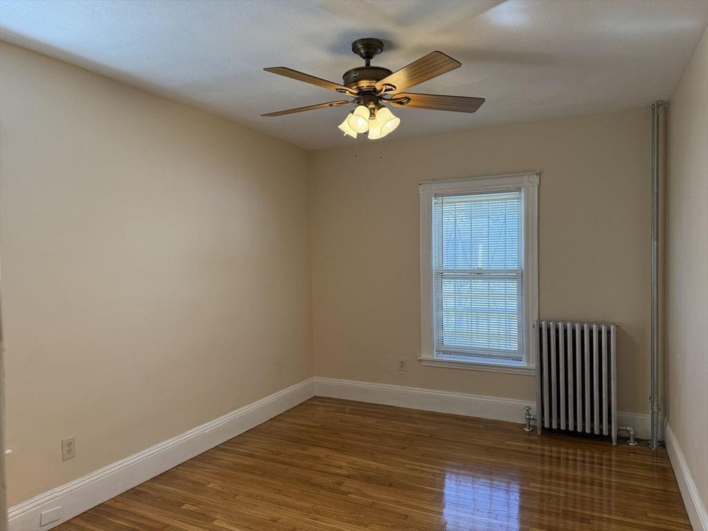 4 Dever Street, Unit 1 Boston, MA 02122 - Photo 17 of 22 a view of empty room with wooden floor and fan