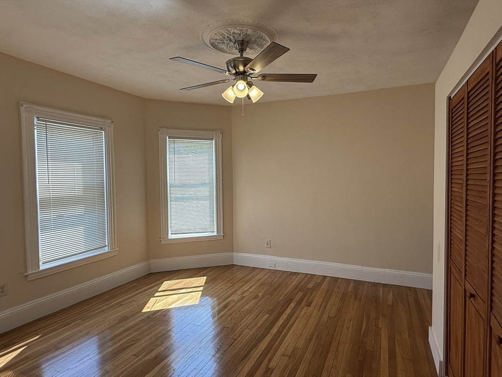 4 Dever Street, Unit 1 Boston, MA 02122 - Photo 19 of 22 a view of empty room with wooden floor and fan