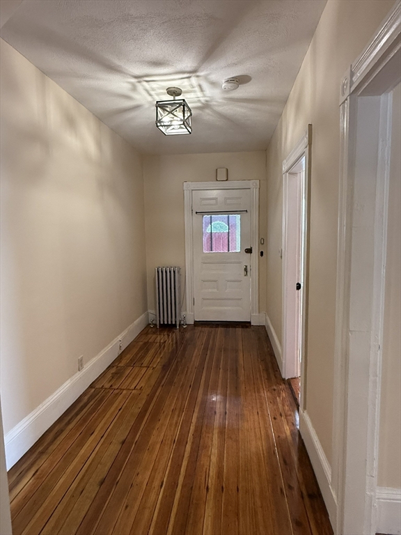 4 Dever Street, Unit 1 Boston, MA 02122 - Photo 20 of 22 a view of an empty room with wooden floor and a window