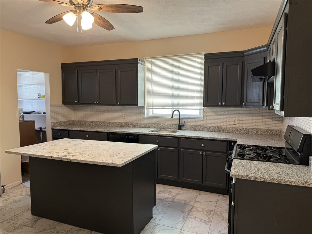 4 Dever Street, Unit 1 Boston, MA 02122 - Photo 2 of 22 a kitchen with a sink a stove and cabinets