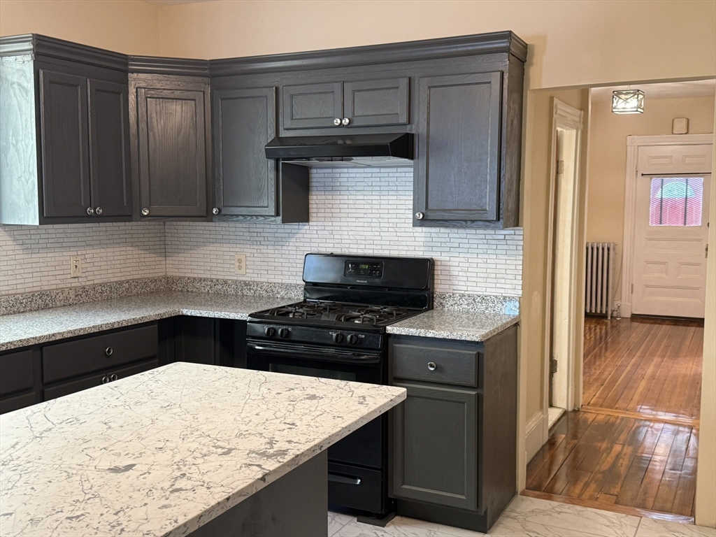 4 Dever Street, Unit 1 Boston, MA 02122 - Photo 6 of 22 a kitchen with a stove and a refrigerator