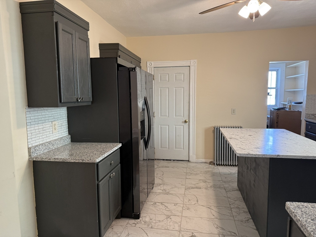 4 Dever Street, Unit 1 Boston, MA 02122 - Photo 8 of 22 a kitchen with stainless steel appliances granite countertop a refrigerator and a sink