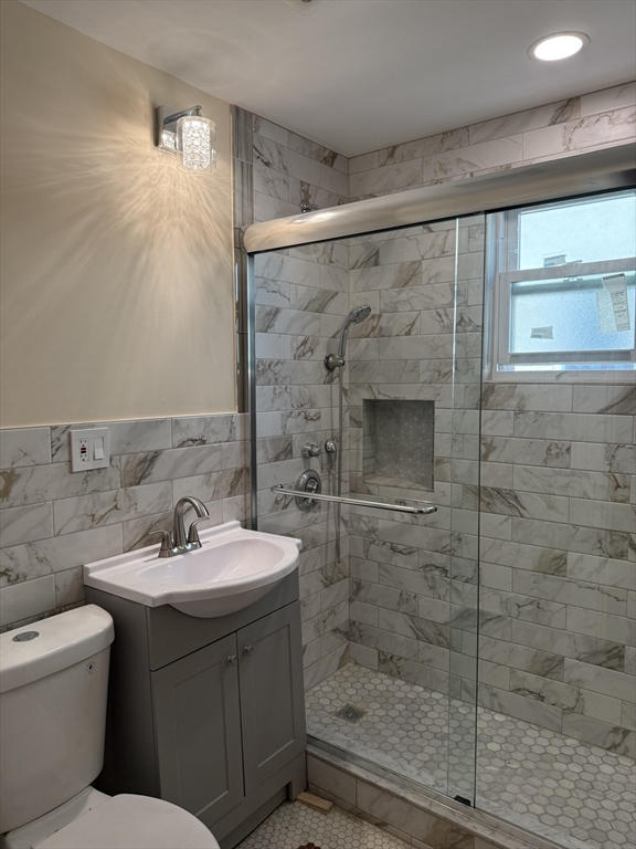 4 Dever Street, Unit 1 Boston, MA 02122 - Photo 10 of 22 a bathroom with a sink mirror and shower