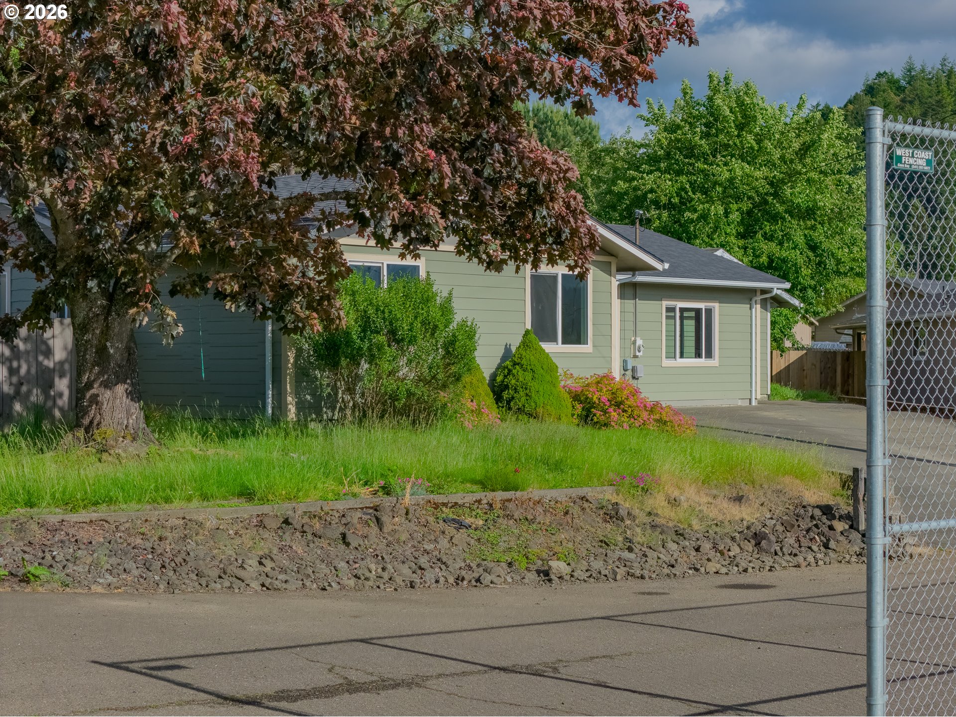 1816 Sunset Court Myrtle Point, OR 97458 - Photo 19 of 42 a front view of a house with garden