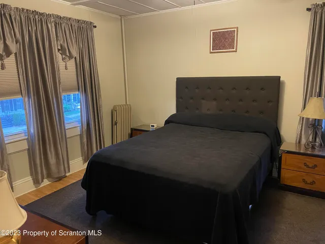 a bed sitting in a bedroom next to a window