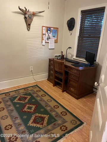 a bed sitting in a bathroom next to a window