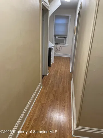 a view of a hallway view with wooden floor