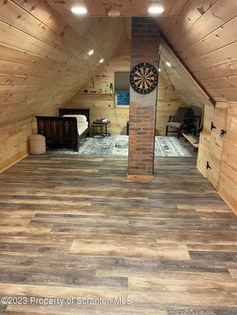 a bedroom with furniture a flat screen tv and a fireplace