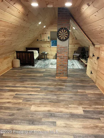 a bedroom with furniture a flat screen tv and a fireplace