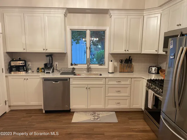 a kitchen with a white cabinets and sink