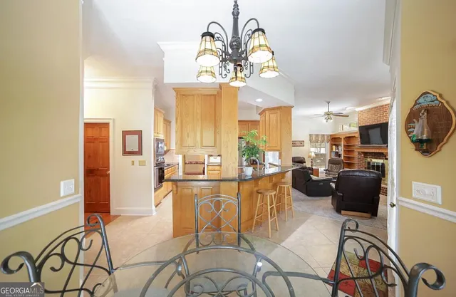 a living room with furniture ceiling fan and a window