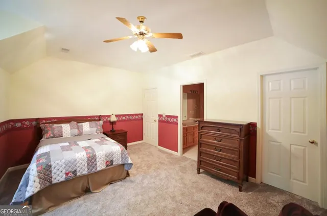 a bedroom with a bed and a mirror on dresser