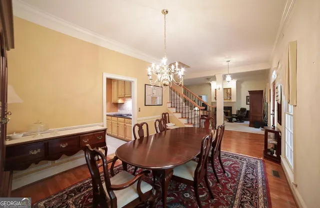 a view of a dining room with furniture and chandelier