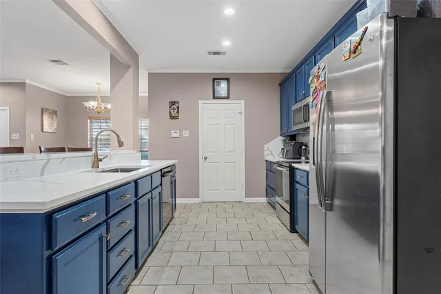 a kitchen with stainless steel appliances kitchen island granite countertop a refrigerator a stove a sink dishwasher with a dining table and chairs