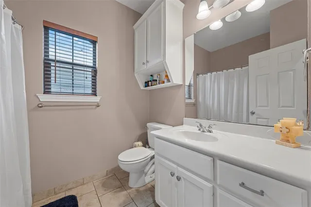 a bathroom with a toilet a sink and a mirror