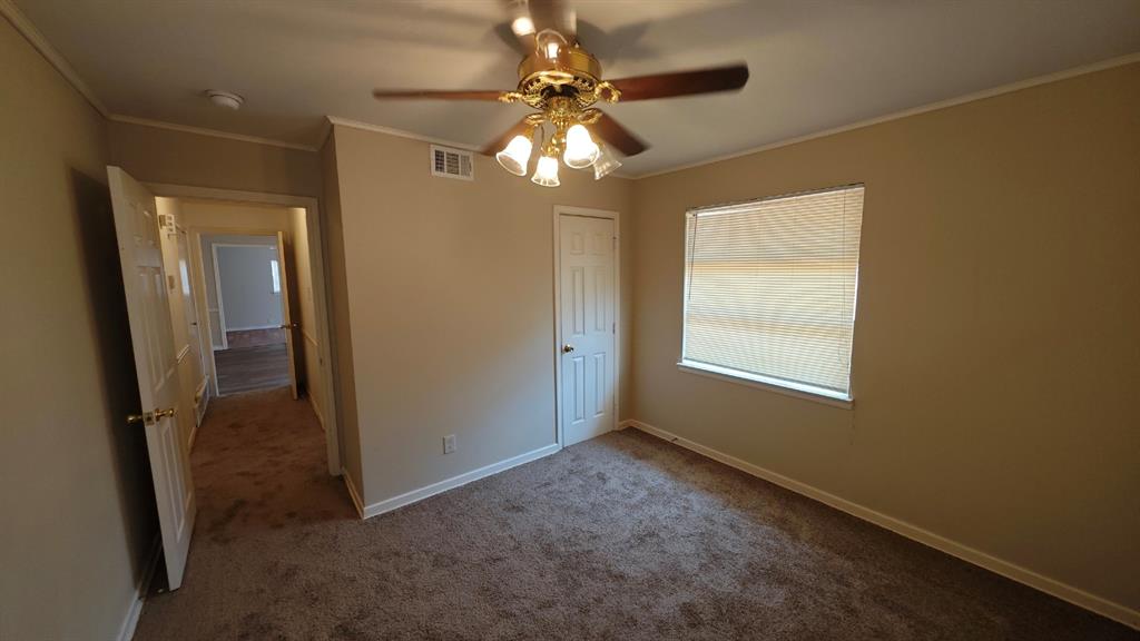 12225 Schroeder Road Dallas, TX 75243 - Photo 25 of 40 Carpeted room featuring a ceiling fan with light fixture, window with blinds, and white paneled doors