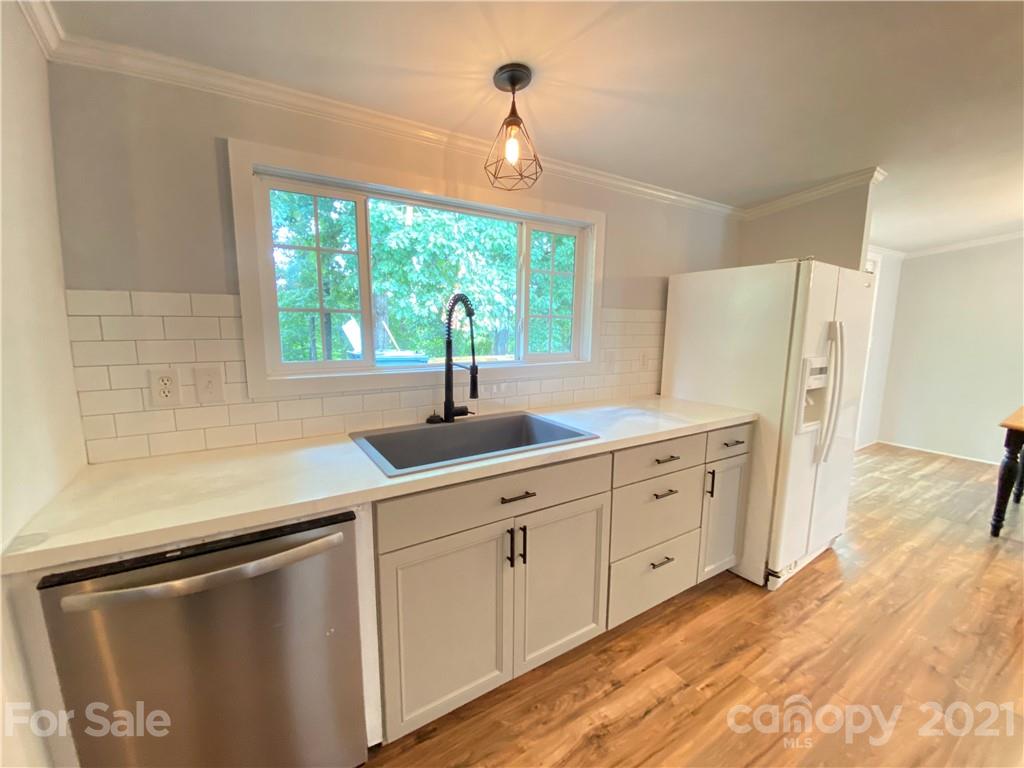 7210 Medlin Road Monroe, NC 28112 - Photo 11 of 30 a kitchen with white cabinets and a large window