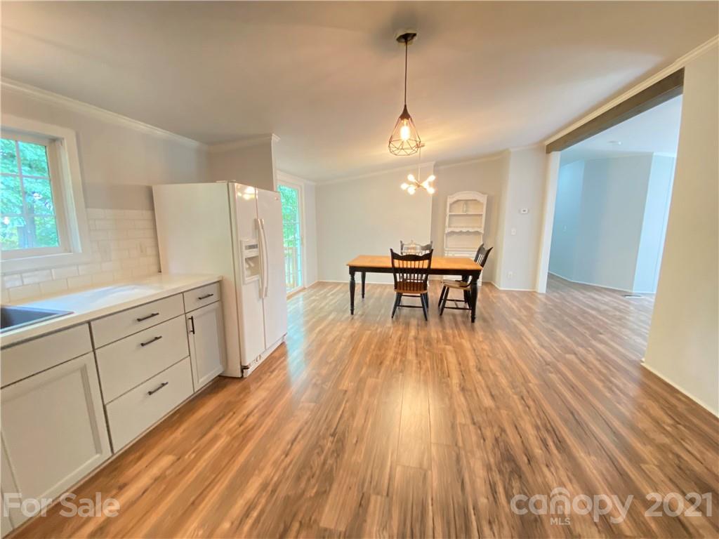 7210 Medlin Road Monroe, NC 28112 - Photo 12 of 30 a view of a dining room with furniture and wooden floor